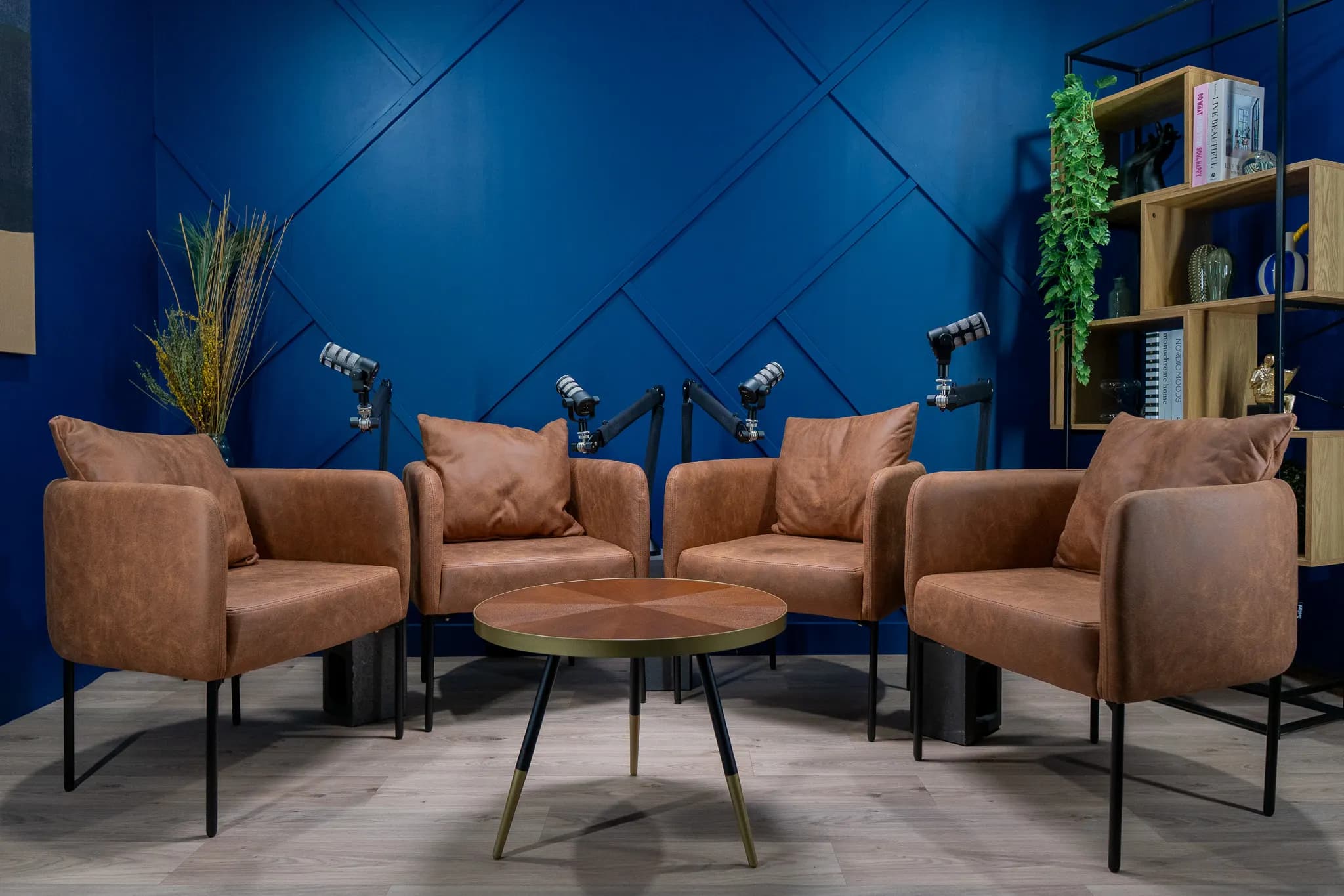 Cognac Room: négy barna bőrfotel kerek, berakásos fa asztal körül, mélykék fal